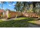 Spacious backyard with lush lawn, privacy wall, and mature palm trees on a bright day at 6935 Date Palm S Ave, St Petersburg, FL 33707