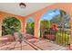 Inviting balcony space with iron furniture and arched openings providing scenic views of the landscaped surroundings at 6935 Date Palm S Ave, St Petersburg, FL 33707