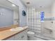 Unique bathroom with glass block shower and wall-mounted octopus art at 6935 Date Palm S Ave, St Petersburg, FL 33707