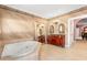 Open bathroom with double vanity, mirrors, and a jacuzzi tub, offering a relaxing spa-like experience at 6935 Date Palm S Ave, St Petersburg, FL 33707