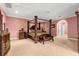 Spacious bedroom with a canopy bed, carpeted floors, and an arched doorway at 6935 Date Palm S Ave, St Petersburg, FL 33707