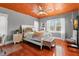 Cozy bedroom features a wood ceiling, plush bed, and natural light from bright windows at 6935 Date Palm S Ave, St Petersburg, FL 33707