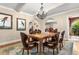 Elegant dining room showcasing hardwood floors, a decorative rug, and an ornate chandelier above a wood table at 6935 Date Palm S Ave, St Petersburg, FL 33707