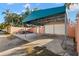 Wide view of the covered parking area, trailer and fenced in yard at 6935 Date Palm S Ave, St Petersburg, FL 33707