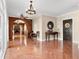 Welcoming foyer featuring terracotta tile flooring, elegant lighting, and arched doorways leading to adjoining rooms at 6935 Date Palm S Ave, St Petersburg, FL 33707
