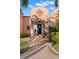 Charming front entrance with terracotta tile walkway, steps with decorative tile risers, and arched door at 6935 Date Palm S Ave, St Petersburg, FL 33707