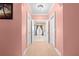 Inviting hallway featuring a carpet runner, neutral walls, and doors leading to various rooms at 6935 Date Palm S Ave, St Petersburg, FL 33707