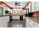 Spacious kitchen featuring modern appliances, generous counter space, and updated cabinets at 6935 Date Palm S Ave, St Petersburg, FL 33707
