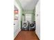 Bright laundry room featuring a washer, dryer, cabinets, and tiled floors at 6935 Date Palm S Ave, St Petersburg, FL 33707