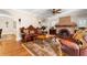 Cozy living room showcasing a stone fireplace, hardwood floors, and ornate furniture creating an inviting atmosphere at 6935 Date Palm S Ave, St Petersburg, FL 33707