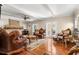 Elegant living room with hardwood floors, stone fireplace, and french doors, complemented by ornate furnishings at 6935 Date Palm S Ave, St Petersburg, FL 33707