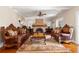 Elegant living room boasts a stone fireplace, ornate furniture, and hardwood floors at 6935 Date Palm S Ave, St Petersburg, FL 33707