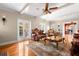 Spacious living room with hardwood floors, french doors, and classic furniture, illuminated by natural light at 6935 Date Palm S Ave, St Petersburg, FL 33707