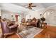 Stately living room featuring hardwood floors, ornate furniture, and abundant natural light at 6935 Date Palm S Ave, St Petersburg, FL 33707