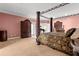 Spacious main bedroom featuring a canopy bed, decorative trim, and views to a music room at 6935 Date Palm S Ave, St Petersburg, FL 33707
