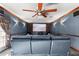 Cozy home theater with plush seating, a large screen, and sconce lighting at 6935 Date Palm S Ave, St Petersburg, FL 33707