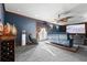 Home theater room with comfortable seating, large screen, projector, and stylish wet bar for entertainment at 6935 Date Palm S Ave, St Petersburg, FL 33707