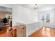 Second floor landing showcasing wood floors and decorative trim with natural light from a window at 6935 Date Palm S Ave, St Petersburg, FL 33707
