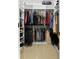 An organized walk-in closet with shelving provides ample storage space for clothes, shoes, and accessories at 6935 Date Palm S Ave, St Petersburg, FL 33707