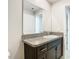 Stylish bathroom with granite countertop, dark cabinets and a large mirror at 7132 Samuel Ivy Dr, Tampa, FL 33619