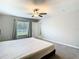 Serene bedroom featuring a window with neutral walls, carpet, and a ceiling fan at 7132 Samuel Ivy Dr, Tampa, FL 33619