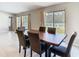 Dining area with a wood table and upholstered chairs, next to sliding doors to the back yard at 7132 Samuel Ivy Dr, Tampa, FL 33619