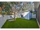 Artificial grass backyard offers a swing and low-maintenance outdoor space for recreation and enjoyment at 7325 S Trask St, Tampa, FL 33616