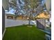 Artificial grass backyard offers a swing and low-maintenance outdoor space for recreation and enjoyment at 7325 S Trask St, Tampa, FL 33616