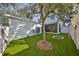 Landscaped backyard with artificial grass, offering a low-maintenance outdoor space for recreation and enjoyment at 7325 S Trask St, Tampa, FL 33616