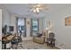 Bedroom featuring a ceiling fan, recliner, and desk area with natural light at 7325 S Trask St, Tampa, FL 33616