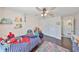 Bright bedroom featuring a ceiling fan, wood floors, closet and playful decor, offering a cozy and inviting atmosphere at 7325 S Trask St, Tampa, FL 33616