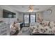 Bright bedroom with a ceiling fan, desk, and a mounted TV above the bed at 7325 S Trask St, Tampa, FL 33616