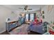 Bright bedroom featuring dark floors, ceiling fan, and multiple storage areas at 7325 S Trask St, Tampa, FL 33616