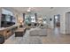 Cozy living room featuring a plush gray sofa, entertainment center, and ample natural light at 7325 S Trask St, Tampa, FL 33616