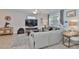 Bright living room with comfortable gray seating, decorative rug, and entertainment center at 7325 S Trask St, Tampa, FL 33616