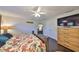 Bright and spacious main bedroom features a walk-in closet, wood floors, ceiling fan and TV at 7325 S Trask St, Tampa, FL 33616