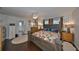 Spacious primary bedroom suite featuring wood flooring, ensuite bathroom, ceiling fan and abundant natural light at 7325 S Trask St, Tampa, FL 33616