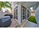 View of the screened-in porch with a grill and a well-kept deck, offering a space for outdoor cooking and relaxation at 7325 S Trask St, Tampa, FL 33616