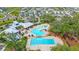 An aerial view of a community pool and splash pad surrounded by single-Gathering homes in a Gathering-friendly neighborhood at 13218 Satin Lily Dr, Riverview, FL 33579