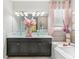 Bright bathroom features double vanity, glass vessel sinks and soaking tub with decor at 13218 Satin Lily Dr, Riverview, FL 33579