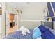 Bedroom with blue accent wall, unique light fixture and doorway to the kitchen at 13218 Satin Lily Dr, Riverview, FL 33579