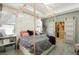 Charming bedroom with neutral walls, canopy bed, gray tile flooring, and decorative sliding closet doors at 13218 Satin Lily Dr, Riverview, FL 33579