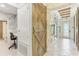 Grand foyer featuring decorative wooden sliding doors and natural stone accent wall at 13218 Satin Lily Dr, Riverview, FL 33579