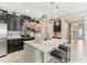 Lovely kitchen featuring an island, bar seating, stone accents, and dark cabinetry at 13218 Satin Lily Dr, Riverview, FL 33579