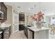 Stylish kitchen with a center island, modern fixtures, pantry, and view into the dining room at 13218 Satin Lily Dr, Riverview, FL 33579