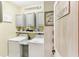 Organized laundry room features cabinets, farmhouse decor and front load machines at 13218 Satin Lily Dr, Riverview, FL 33579