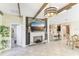 Open living space with a fireplace, eat-in kitchen, dining area, and natural lighting at 13218 Satin Lily Dr, Riverview, FL 33579