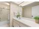 Well-lit bathroom with shower/tub, a large mirror, and ample counter space at 100 Sylvia Pl, Oldsmar, FL 34677