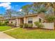 Charming condo featuring a landscaped lawn, manicured bushes, and a welcoming pathway at 100 Sylvia Pl, Oldsmar, FL 34677