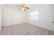 Cozy bedroom offers a clean design with tile flooring, natural light, and ample space for a serene retreat at 1004 Hallwood Loop, Brandon, FL 33511